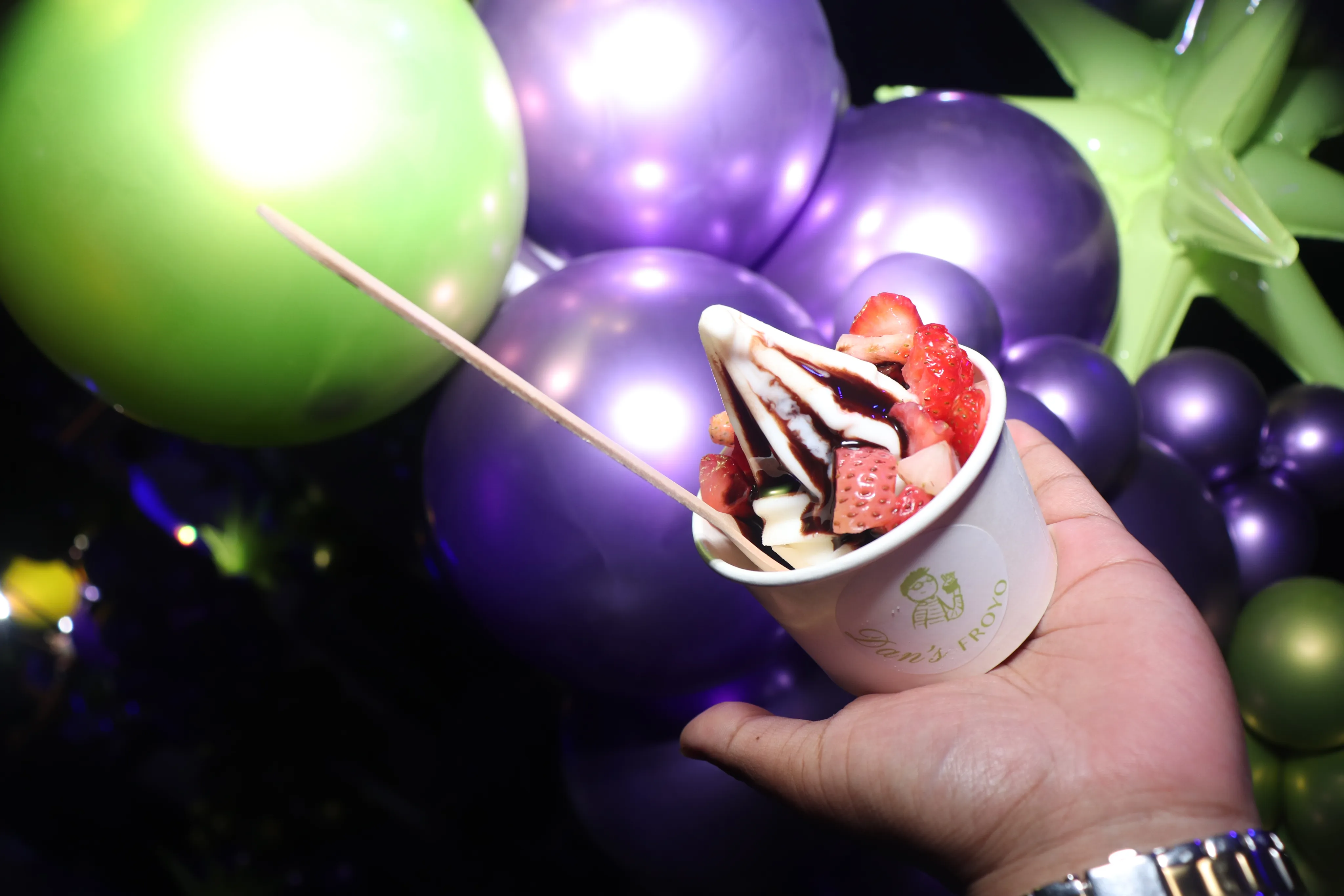 Guests enjoying frozen yogurt at a colorful birthday party